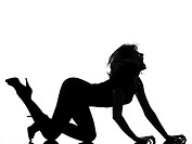 full length silhouette in shadow of a young woman crouching roar in studio on white background isolated