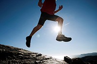 Man leaping through the air whilst running