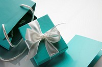 small turquoise box tied with a white ribbon and bag