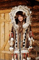 Young Athabascan woman modeling the traditional fur clothing of her native tribe, Chena Indian village, Alaska