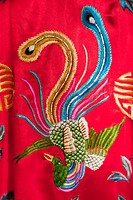 Colourful red Chinese embroidered silk garment depicting a phoenix bird, for sale, China