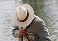 Student spectator in panama hat and old college blazer during Oxford University Eights Week rowing competition, Oxford, England, UK