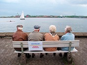 Old couples at free harbour watching sailing boat, Kiel, Germany