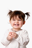Beautiful expressive adorable happy cute laughing smiling baby infant toddler girl with ponytails showing teeth, isolated