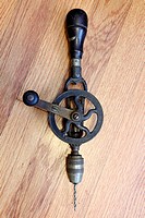 An antique hand cranked drilling tool