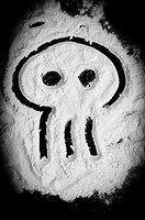 Skull shape drawed on white powder similar to cocaine