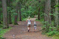 Mother and Young Girl Walking in Forest Holding Hands, Põlva County, Estonia