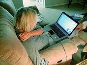 Adult female relaxing with laptop computer