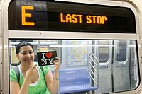 Hispanic, Asian, woman holding ´I Love New York´ postcard, Subway train metro station, New York City