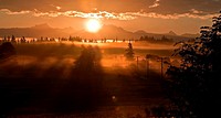 This stunning sunrise is coming over the mountain known as 3 Sisters or 3 Fingers called both commonly in Washington state  A heavy fog is laced in an...