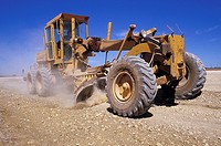 large earth mover grading an outback road