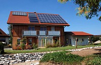 A house with solar roof and a wood-paneled facade