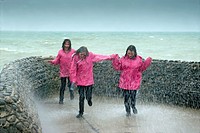 teenagers pink raincoats trio