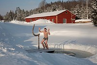 Young Happy Man by Ice Hole in Väike Trommi Tourism Farm, Valga County, Estonia