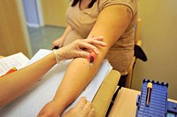 Nurse collecting a blood sample from a patient, Stockholm, Sweden