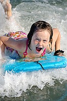 Girl on a wave board enjoying the ride, Ocean City, New Jersey, USA