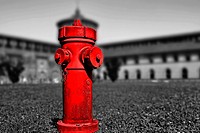 Red in castle, a standpipe in the garden of Castello Sforzesco, Milano, Italy