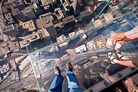 Tourists in the all glass balcony skydeck observation deck view the Chicago skyline103rd floor of the Willis Tower previously the Sears Tower