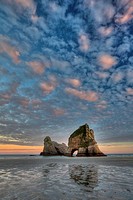 Archway Islands, sunrise lights up high clouds, Wharariki beach, near Collingwood, Golden Bay, New Zealand