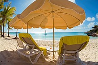 Beach chairs and umbellas on Meads Bay Beach on the caribbean island of Anguilla in the British West Indies