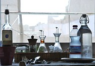Bottles and glasses in front of a window