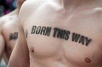 Men with gay pride message stenciled on their bare chests at the Christopher Street Day Parade in Berlin Germany 2011