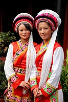 Two girls from Bai Ethnic group dressed in traditional costumes (Bai is one of the 56 ethnic groups officially recognized by the Chinese government), ...