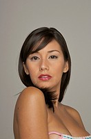 Latin woman topless looking at camera with red lipstick