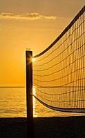 Volleyball net silhouetted aganist sunset sky on Venice Beach Florida