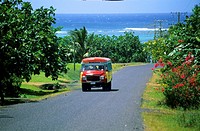 Typical painted bus on a small highway on Samoa islands