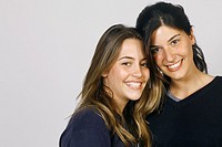 Studio shot of two young women, smiling