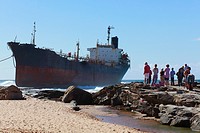 Interested onlookers gaze at the tanker Phoenix, aground on a rocky shelf at Sheffield Beach, KwaZulu Natal, South Africa