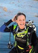 Happy female scuba diver coming up after a dive