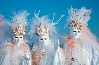 Three persons in costume during Carnivale in Venice, Veneto, Italy