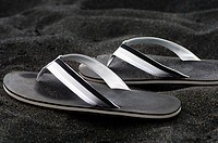 Black sandals on sand