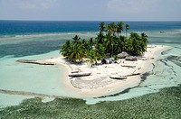 Aerial view of thatched houses and palm tree forest in island  San Blas archipelago, Caribbean, Panama, Central America