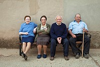 Local people sitting on a bench seat in the village of Las Matillas along the Camino de Santiago
