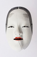 traditional but broken japanese noh theatre mask of ko-omote representing young beauty woman - symbolism of growing older