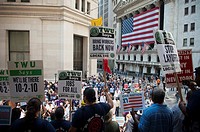 Union members and supporters rally against unemployment in front of Federal Hall, across the street from the New York Stock Exchange in New York