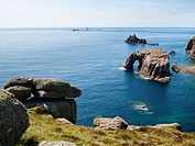Rock formations off the coast at Lands End Cornwall England UK