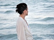 Young woman looking out to sea