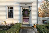 The front door of an old house decorated with a holiday wreath, in the town of Sandwich, Cape Cod, Massachusetts, United States