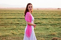 Portrait of a beautiful young woman standing in field