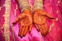 Traditional henna decorations on hand of an Indian bride