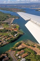 Wing of airplane arriving to Honolulu, Pearl harbor in the background, Oahu Island, Hawaii Islands, USA