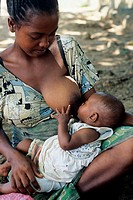 young woman breast-feeding her baby, Republic of Madagascar, Indian Ocean