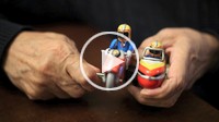 Close up of hands holding an old toy