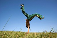 Man practicing capoeira in field