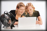 Two teenage girls studying mathematics in front of the laptop