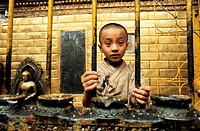 Boy working as a priest in the Golden temple at Patan  Nepal  It´s a tradition among Newars, the original inhabitants of the Kathmandu valley  Every m...